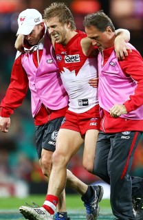 Kieran Jack leaves the field helped by Tim Needham and Nathan Gibbs