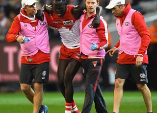 Sydney Swans defender Aliir Aliir goes a medial ligament in his knee - assisted by Senior Physio Tim Needham